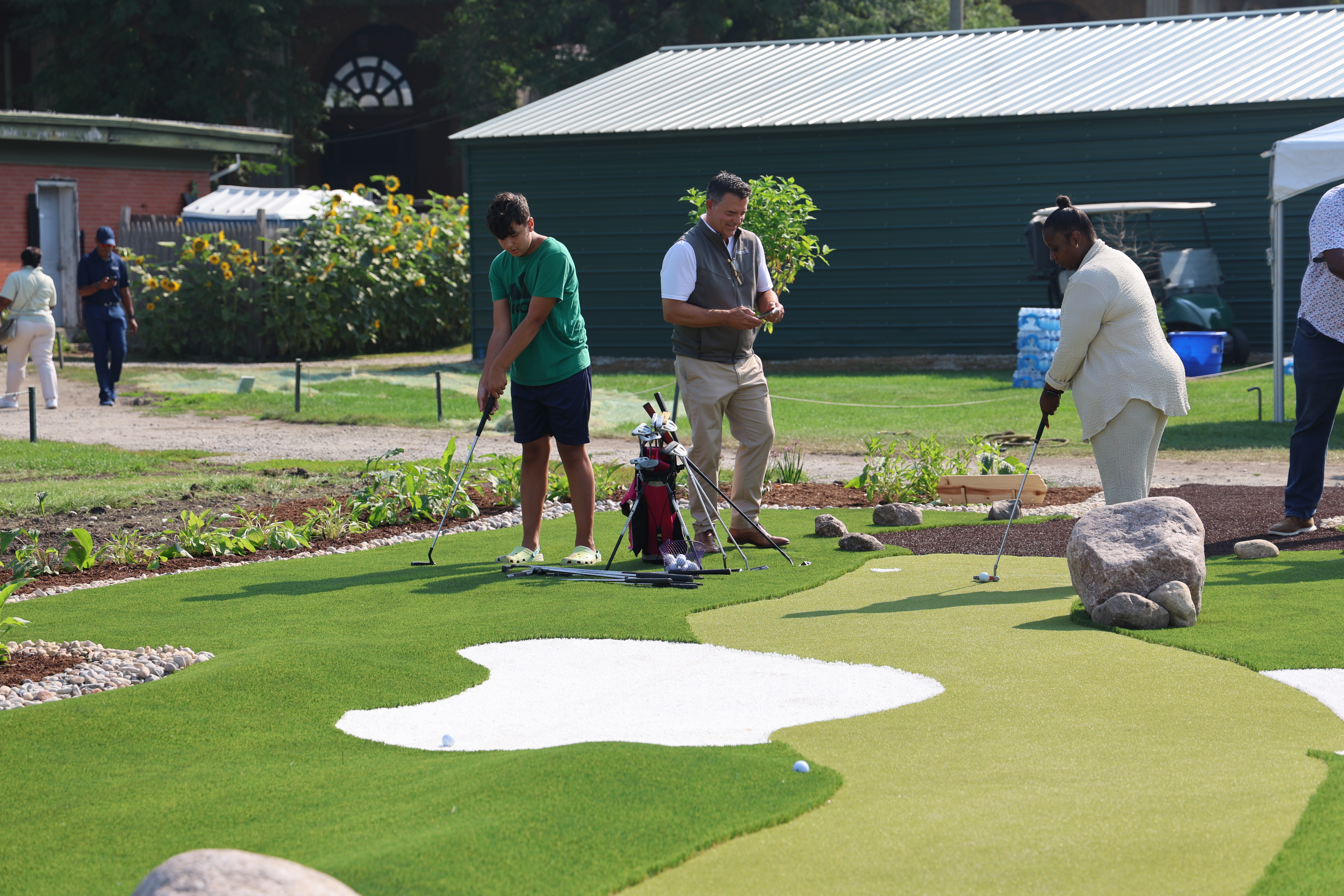 People putting on a small artificial green.